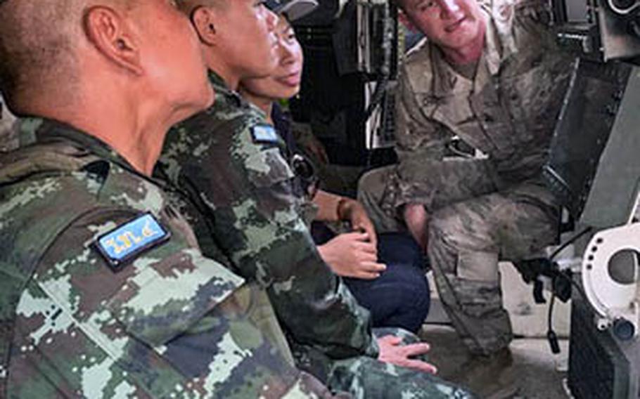 A U.S. soldier explains the capabilities of a Stryker vehicle with Royal Thai Army soldiers during an exchange Feb. 2, 2019, at Camp Nimman Kolayut, Thailand, during Hanuman Guardian.