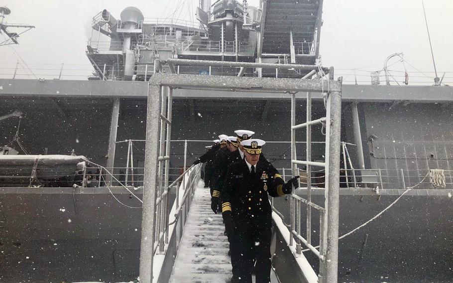 U.S. 7th Fleet commander Vice Adm. Phil Sawyer leads officers off the USS Blue Ridge during a port visit to Otaru, Japan, on Friday, Feb. 8, 2019.
