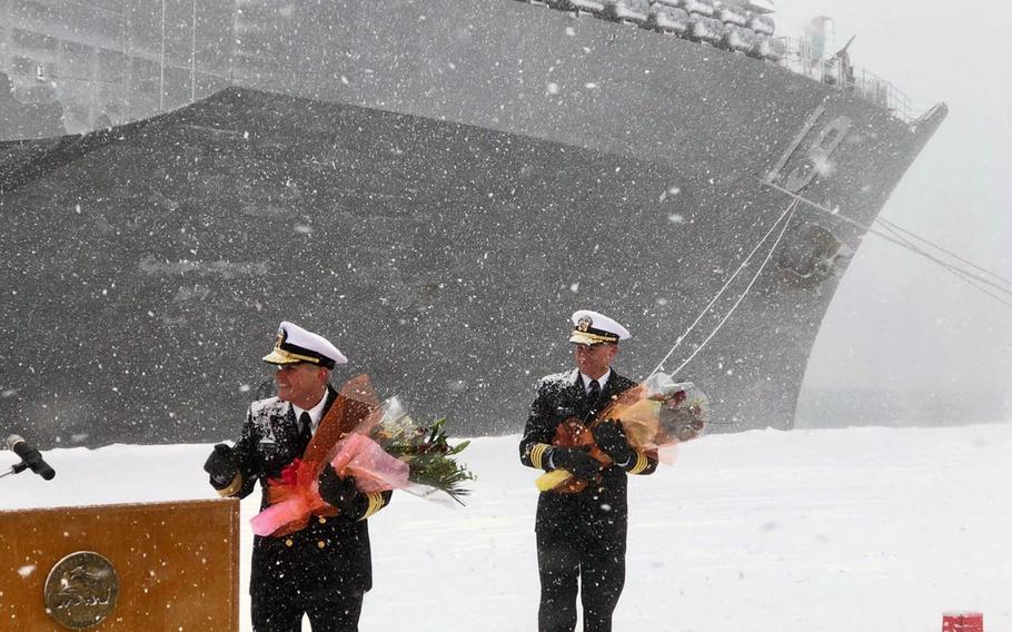 Vice Adm. Phil Sawyer, left, commander of the U.S. 7th Fleet, received flowers from citizens of Otaru, Japan, during a welcoming ceremony for the USS Bue Ridge on Friday, Feb. 8, 2019.