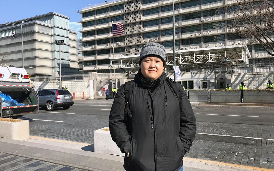 Tong Yi, known as Don to family and friends, poses in front of the U.S. Embassy in Seoul, South Korea, before going to a meeting there to discuss his case, Monday, Feb. 11, 2019.