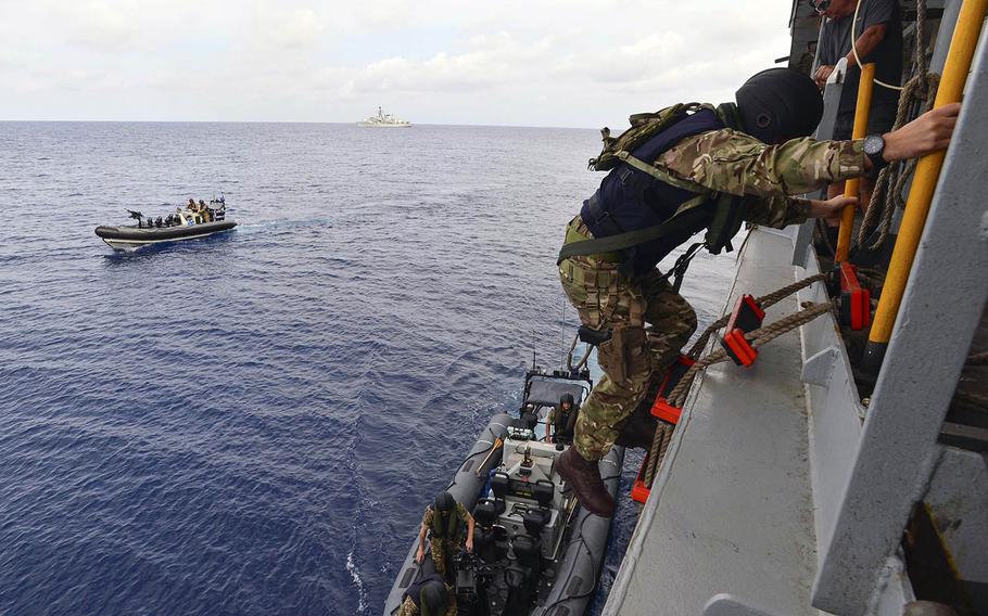 Royal Marine commandos and Royal Navy sailors from the frigate HMS Montrose conduct a search-and-seizure drill aboard the fleet replenishment oiler USNS Guadalupe in the South China Sea on Monday, Feb. 18, 2019.