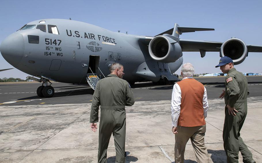 U.S. Ambassador to India Kenneth Juster walks with airmen toward a C-17 Globemaster III at Air Force Station Yelahanka, Bengaluru, India, Feb, 20, 2019.