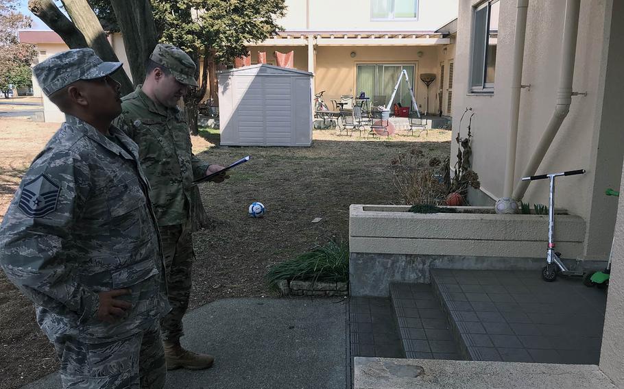 Master Sgt. Adam Brady, right, and Master Sgt. Paul On surveyed residents of Yokota Air Base, Japan, housing Friday, Feb. 22, 2019, about issues with their base homes.