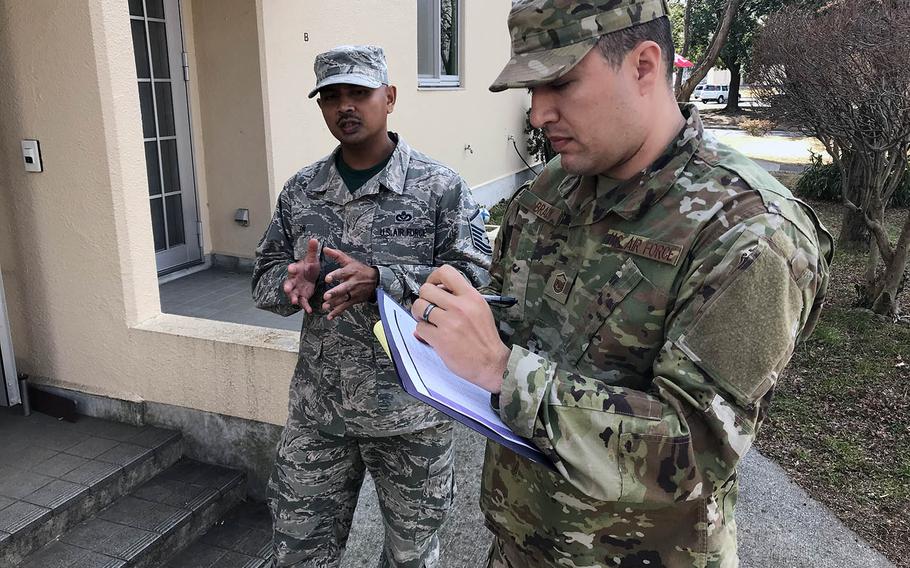Master Sgt. Adam Brady, right, and Master Sgt. Paul On visited Yokota Air Base eastside housing in Japan on Friday, Feb. 22, 2019, to ask residents about issues with their single-story row homes.