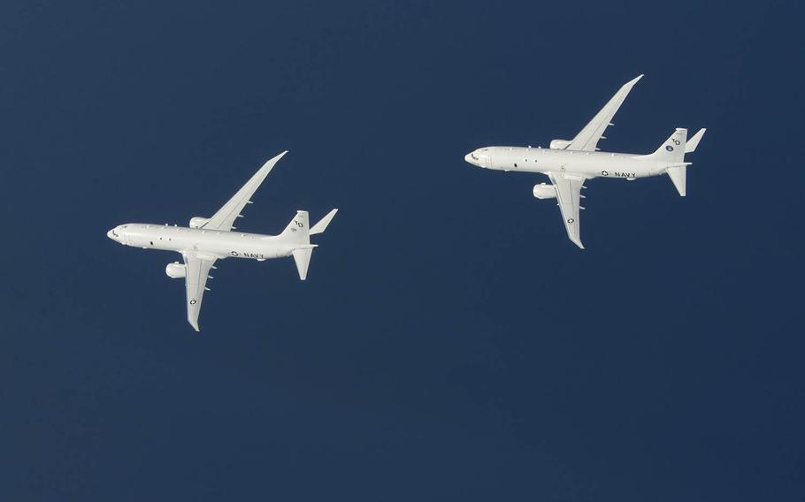 Two U.S. Navy P-8A Poseidon aircraft fly in formation over the East China Sea on Sept. 20, 2018. A Navy squadron is showing the anti-submarine patrol plane at an Australian airshow this week.