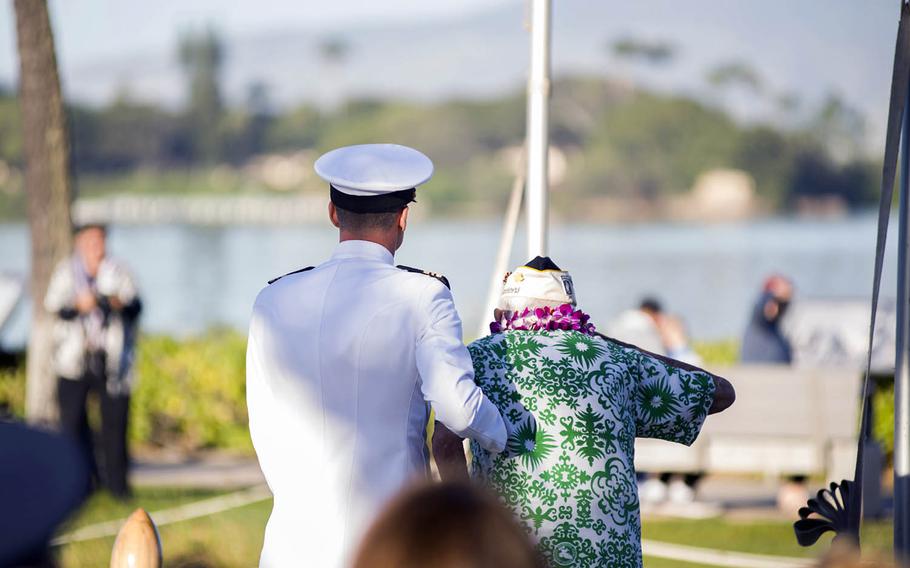Lt. Cmdr. Michael Genta assists Al Rodrigues, right, during a ceremony at Joint Base Pearl Harbor-Hickam, Hawaii, on Dec. 7, 2017. Rodrigues died Sunday, Feb. 24, 2019.