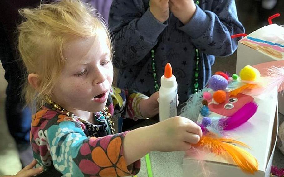 Paige Relethford, 4, decorates her miniature float during the USO's Mardi Gras celebration at Yokosuka Naval Base, Japan, Tuesday, March 5, 2019.