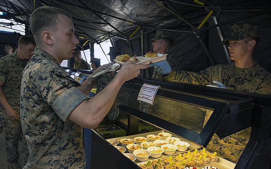 A Marine receives a build-your-own Okinawa taco rice meal entered in for judging during the W.P.T. Hill award competition at Camp Kinser, Okinawa, Japan, on March 14, 2019.