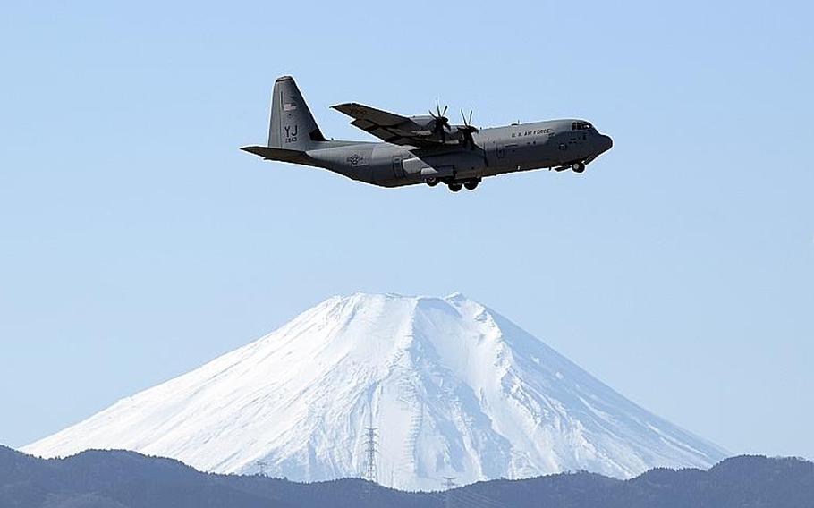 A C-130J Super Hercules assigned to the 36th Airlift Squadron flies over Yokota Air Base, Japan, with Mount Fuji in the background, Jan. 8, 2019.