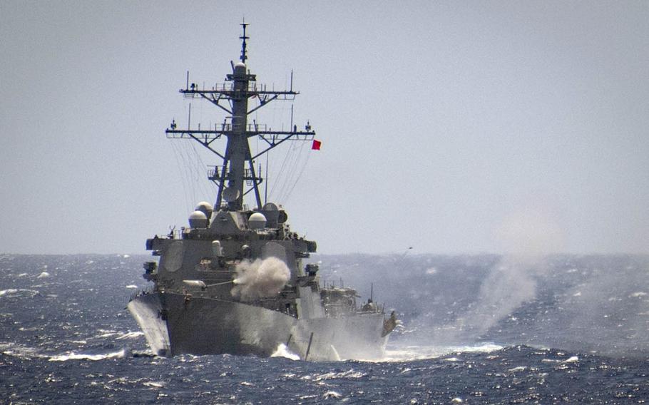 The guided-missile destroyer USS Curtis Wilbur fires its 5-inch gun during an exercise in the Philippine Sea, March 10, 2019.