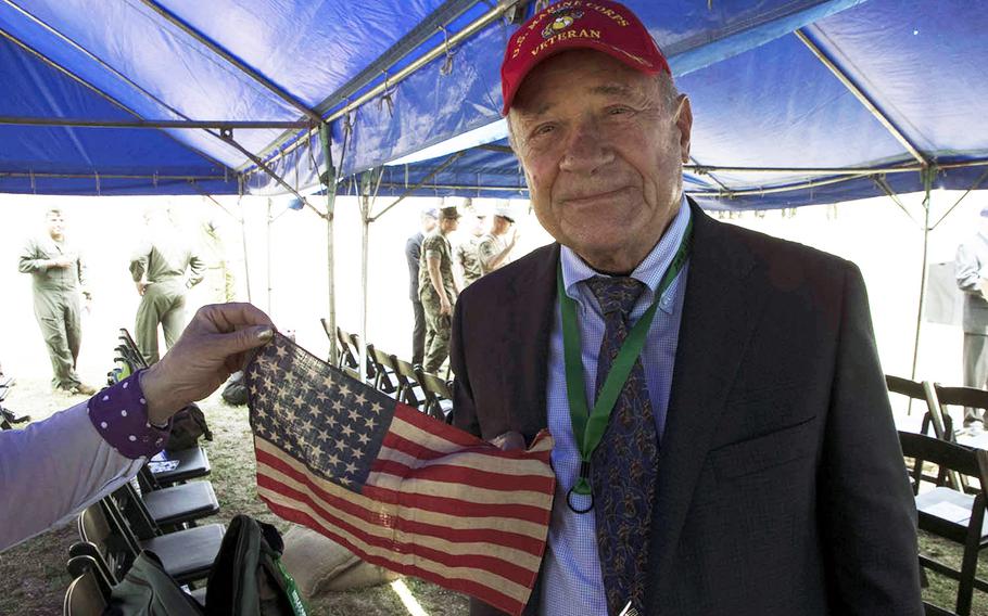 Retired Marine Capt. Robert W. Van Camp on March 23, 2019, during a 74th anniversary ceremony holds a flag that was carried by his father, Gunnery Sgt. Robert Van Camp, during the Battle of Iwo Jima, Japan, in February 1945. 