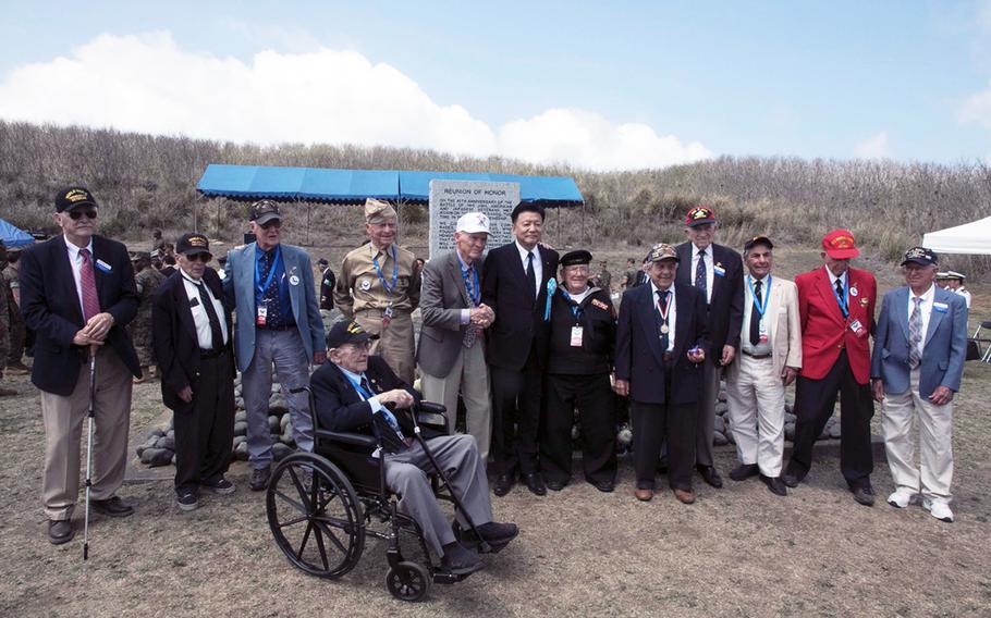 Veterans of the Iwo Jima campaign pose for a photo on Saturday, March 23, 2019, on Iwo Jima, Japan, with Japanese House of Representatives member Yoshitaka Shindo, whose grandfather, Gen. Tadamichi Kuribayashi, was garrision commander of Iwo Jima during the 1945 battle.