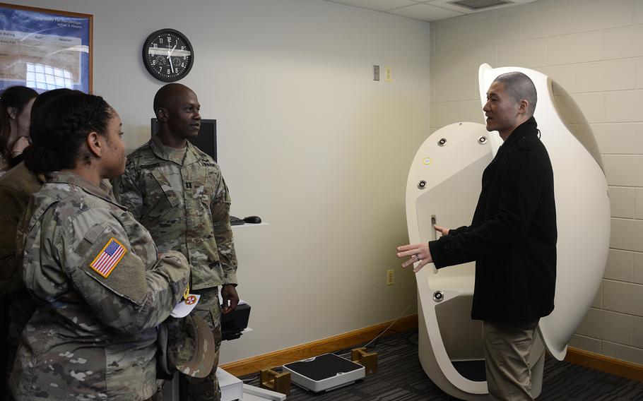Soldiers listen as John Sim, right, director of the new Army Wellness Center at Camp Humphreys, South Korea, explains how to use the BOD POD, which measures body fat and muscle composition, Friday, March 22, 2019.