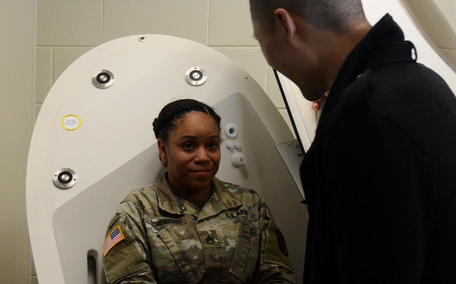 A soldier tries out the BOD POD, which measures body fat and muscle composition, as John Sim, director of the new Army Wellness Center at Camp Humphreys, South Korea, explains how it works, Friday, March 22, 2019.