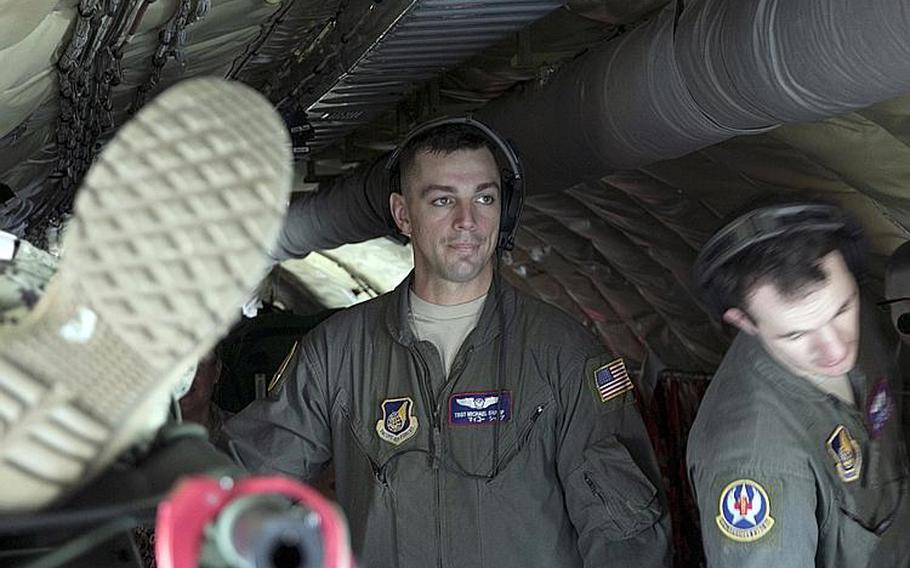 Tech Sgt. Michael Shamp of the 18th Aeromedical Evacuation Squadron watches as the next simulated casualty is loaded onto a KC-135 Stratotanker during a mass-casualty medical training exercise Kadena Air Base, Okinawa, Wednesday, March 27, 2019.