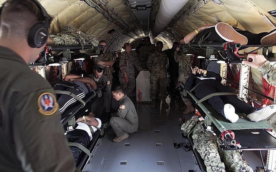 Airmen from the 18th Aeromedical Evacuation Squadron load simulated casualties aboard a KC-135 Stratotanker during a mass-casualty medical training exercise Kadena Air Base, Okinawa, Wednesday, March 27, 2019.