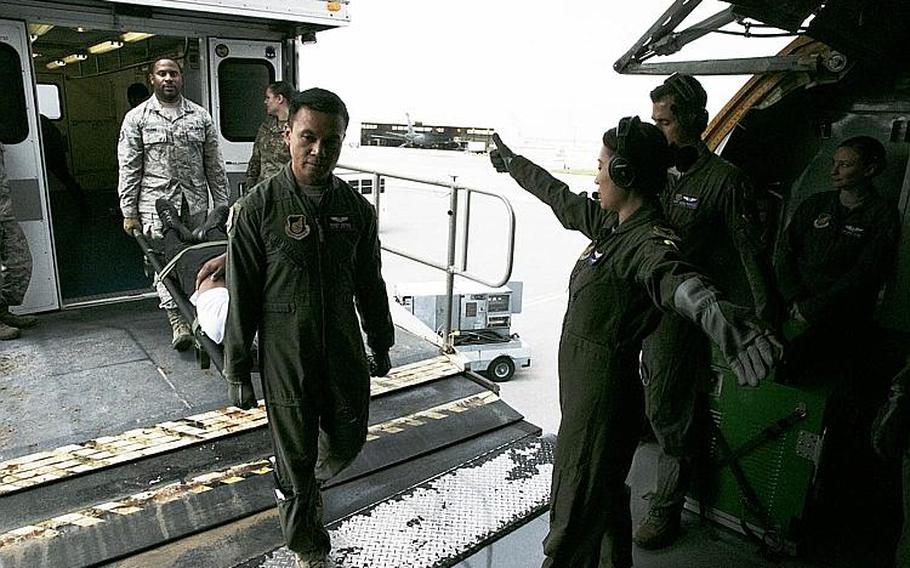 Airmen from the 18th Medical Group and 18th Aeromedical Evacuation Squadron transfer simulated casualties from a high-deck patient loading platform vehicle to a KC-135 Stratotanker during an exercise at Kadena Air Base, Okinawa, Wednesday, March 27, 2019.