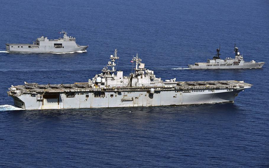 The USS Wasp, center, maneuvers alongside the Philippine navy's BRP Tarlac, left, and BRP Ramon Alcaraz in the South China Sea during the Balikatan exercise on April 5, 2019.