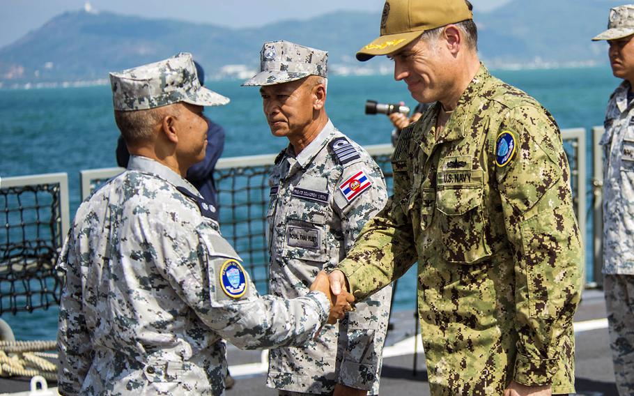 Capt. Matt Jerbi, commodore, Destroyer Squadron 7, right, greets Royal Thai Navy Rear Adm. Kamjorn Charoenkiat during the Guardian Sea opening ceremony in Phuket, Thailand, on Sunday, April 7, 2019.