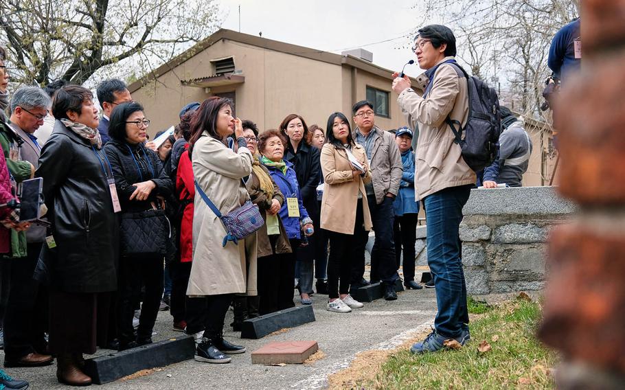 Kim Chun-soo, director of history and culture at Yongsan Cultural Center, describes for visitors the historic Japanese military stockade inside Yongsan Garrison, South Korea, on Tuesday, April 9, 2019.