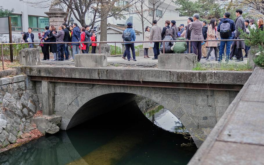 South Koreans tour a historic Japanese pedestrian bridge inside Yongsan Garrison, South Korea, on Tuesday, April 9, 2019.