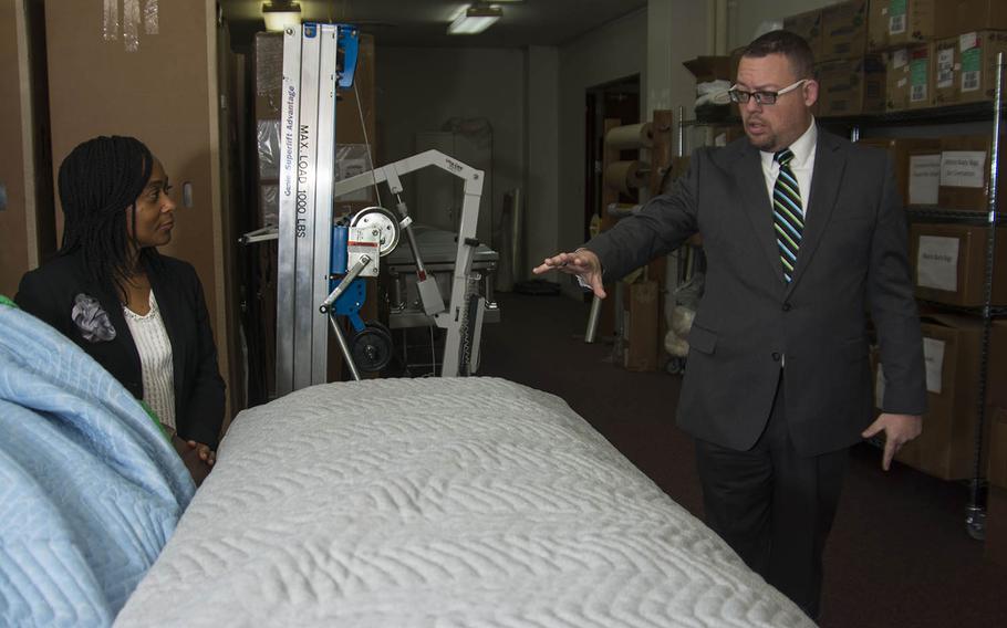 Matthew Metschke, right, director of Pacific Air Forces Western Pacific Regional Mortuary, and assistant director Mable Justice explain the scope of their work during a tour at Yokota Air Base, Japan, Feb. 6, 2019.