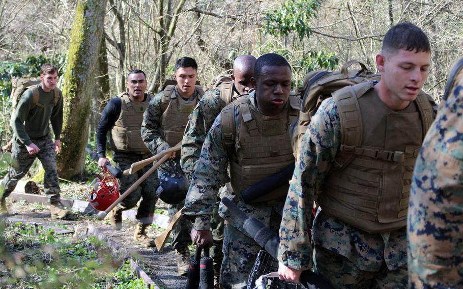 Marines tote their gear for the Marine Corps Martial Arts Instructor course at Combined Arms Training Center Camp Fuji, Gotemba, Japan, on Wednesday, April 10, 2019.