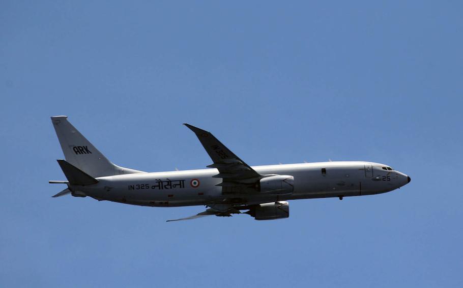 An Indian navy P-8I Neptune conducts a low altitude fly-by alongside the guided-missile destroyer USS Spruance during an anti-submarine warfare exercise in the Indian Ocean, April 15, 2019.