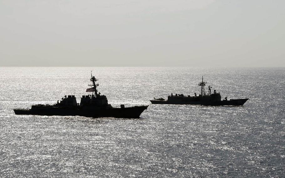 The USS Preble and the Australian frigate HMAS Melbourne move in formation on the Philippine Sea on Thursday, April 18, 2019.