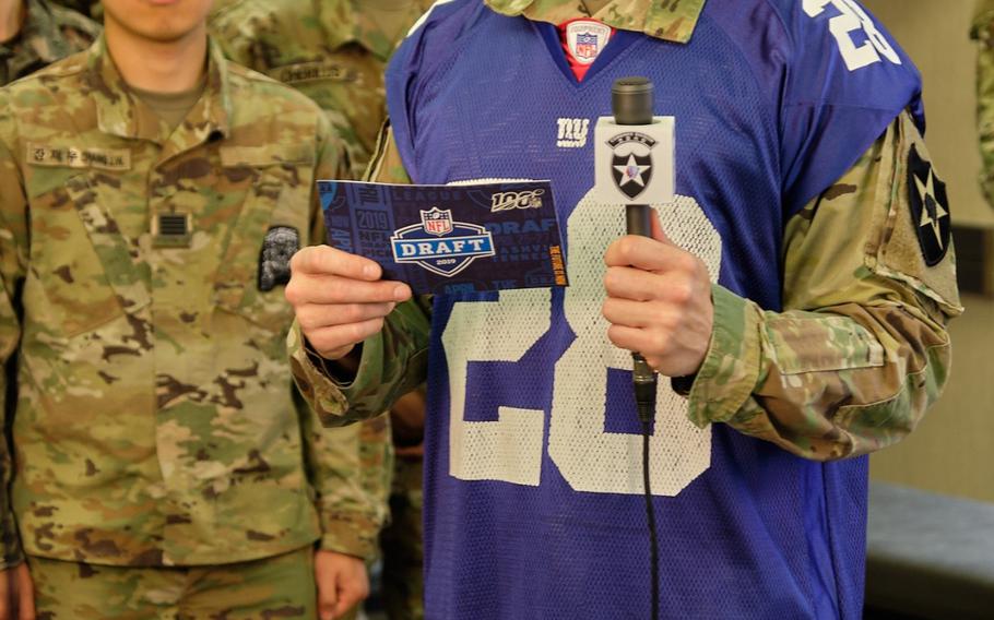 Warrant Officer James Benecke of the 2nd Sustainment Brigade announces the New York Giants' second pick in the 2019 NFL Draft from Camp Humphreys, South Korea, Friday, April 26, 2019. 