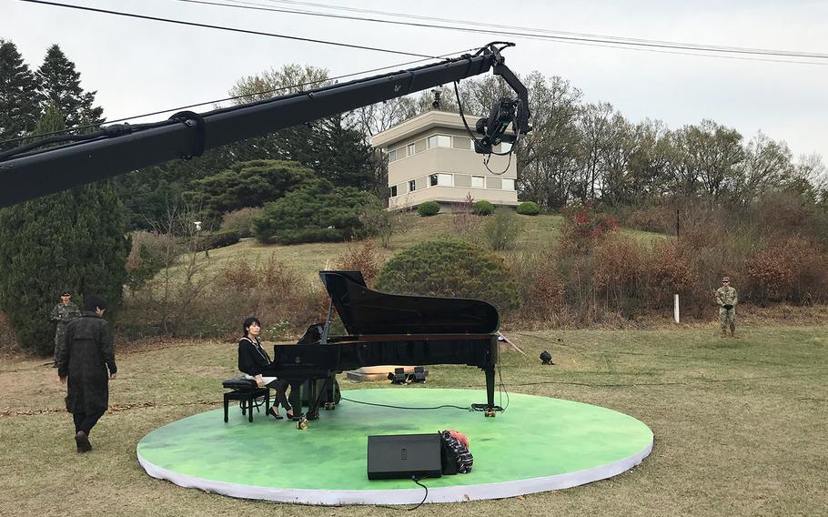 A pianist performs near the pine tree planted by South Korean President Moon Jae-in and North Korean leader Kim Jong Un in the truce village of Panmunjom, Saturday, April 27, 2019.