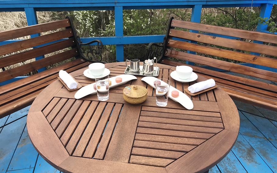 The table on the foot bridge where the North and South Korean leaders held a private chat was laid out with macarons and tea cups to recreate the scene for celebrations of the first anniversary of the first inter-Korean summit, Saturday, April 27, 2019.