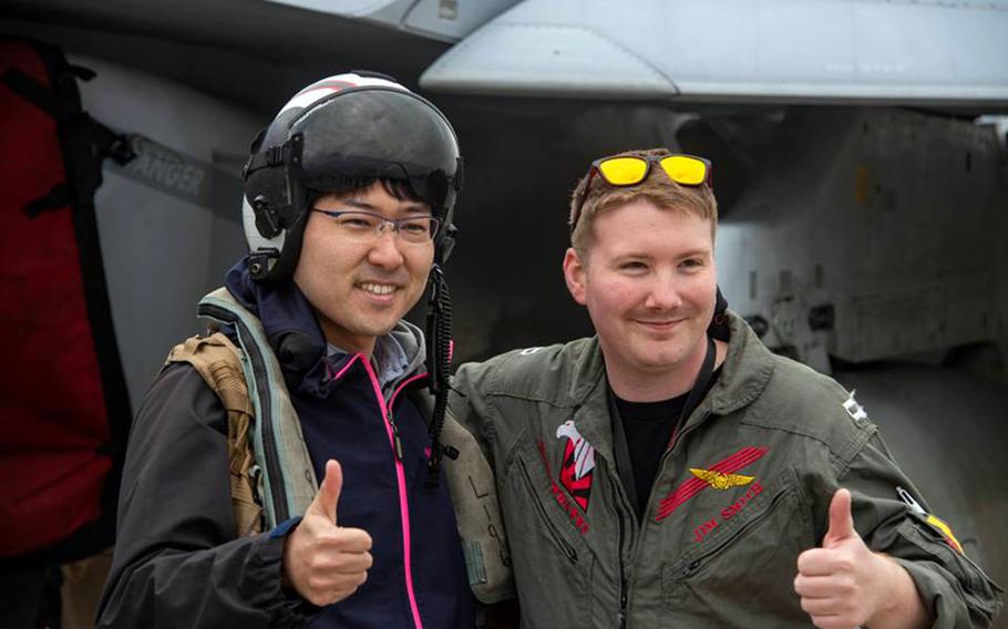 A U.S. servicemember poses with a guest during the Spring Festival at Naval Air Facility Atsugi, Japan, Saturday, April 27, 2019.