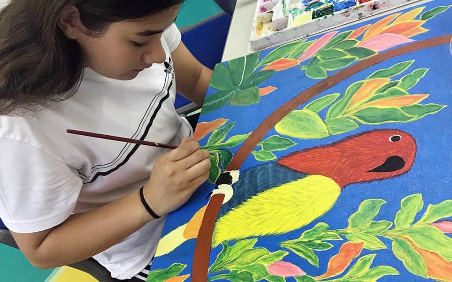 Constance Jones, a senior at Zama American High School in Japan, works on a painting called "Bird on Branch," during the Far East Film and Creative Expressions Festival in Tokyo, May 2, 2019.