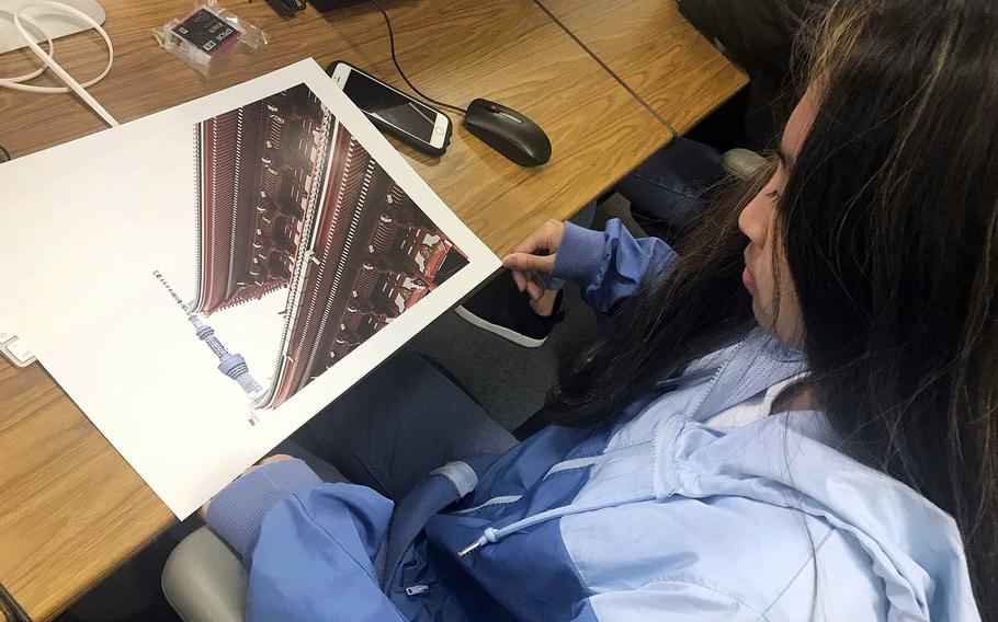 Skylabelle Jimenez, a junior at Nile C. Kinnick High School on Yokosuka Naval Base in Japan, looks over her photograph during the Far East Film and Creative Expressions Festival in Tokyo, May 2, 2019.