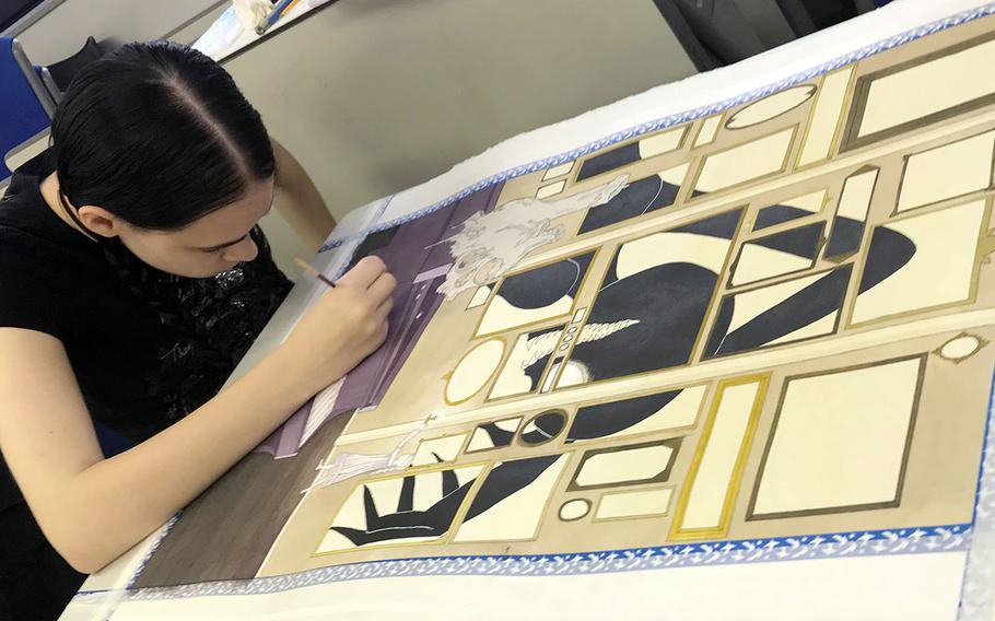 Meaghan Nelson, a junior at Yokota High School in Japan, works on her award-winning painting, "What Lurks in the Shadows," during the Far East Film and Creative Expressions Festival in Tokyo, May 2, 2019.