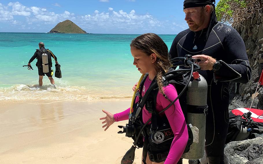 Matt Kuderickis instructs McKenzie DeYoung on the basics of scuba diving at the beach beside the Paul Mitchell Estate in Lanikai, Hawaii, May 5, 2019.