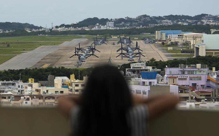 A child looks out at aircraft at Marine Corps Air Station Futenma, Okinawa, April 19, 2019.