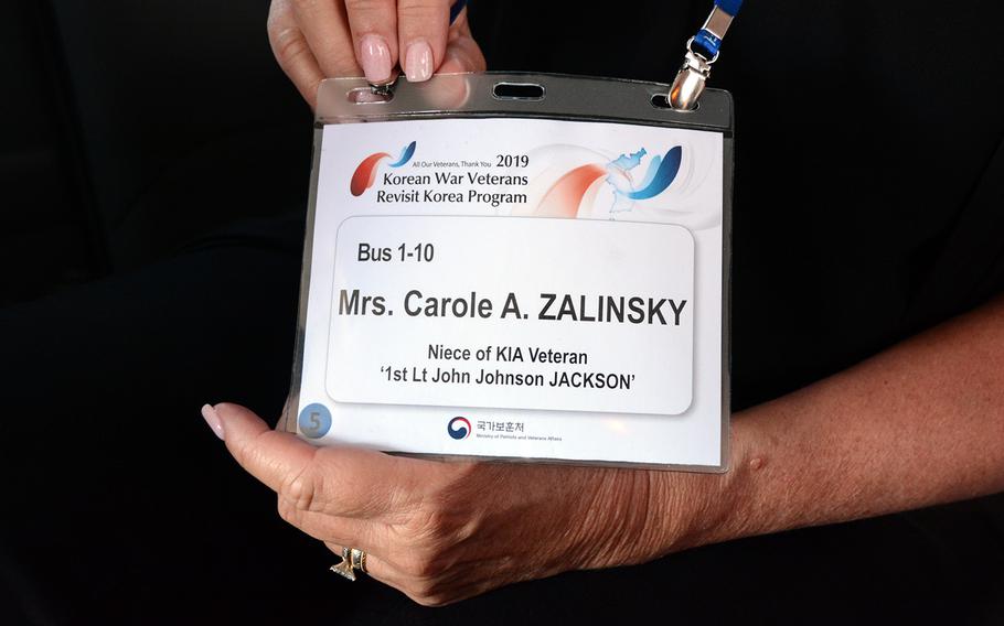 Carole Zalinksky of Clark, N.J., displays a nametag showing that she is the niece of Air Force 1st Lt. John Johnson Jackson, who was shot down over North Korea in 1950. She joined other relatives of missing U.S. servicemembers in a visit to the former Korean War battleground known as Arrowhead Hill, May 29, 2019.