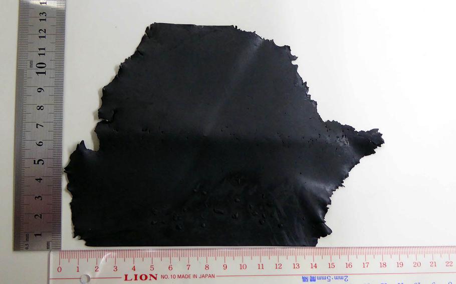 No injuries or damage was reported after this small piece of rubber landed on an Okinawa middle school tennis court, Tuesday, June 4, 2019. The Marine Corps later confirmed that it is blade tape from a CH-53E Super Stallion helicopter.