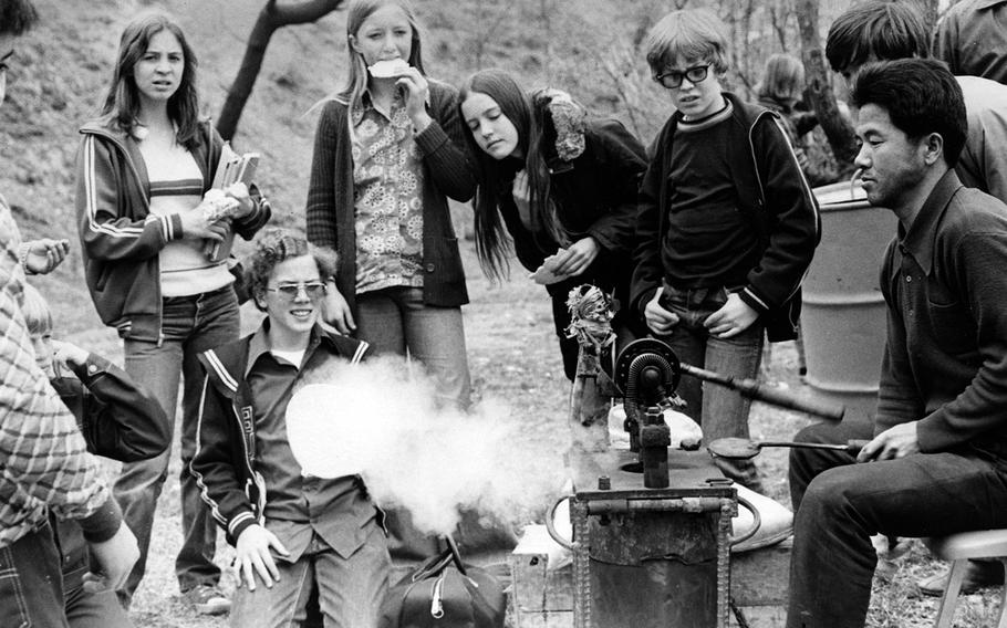 Seoul American students sample Korean rice puffs outside the school at Yongsan Garrison, South Korea, in April 1976.