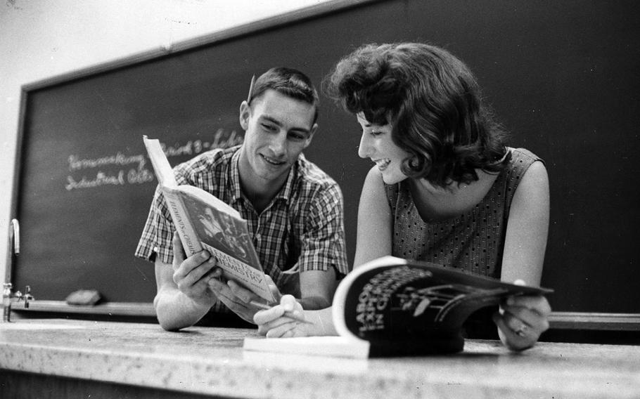 Seoul American seniors Bruce Church and Susan Scott look over their chemistry books on the first day of classes in September 1961.