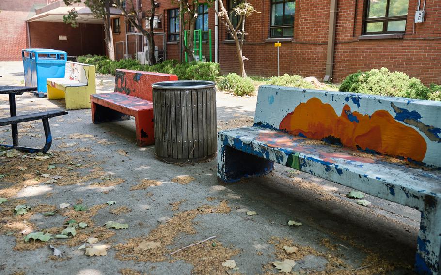 Benches painted over the years by Seoul American students are seen at the campus on Yongsan Garrison, South Korea, Wednesday, June 5, 2019.