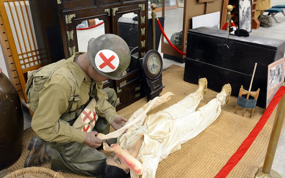 A display showing an American medic treating a wounded Korean woman in a traditional home is seen at the new 2nd Infantry Division/Eighth Army/Korean Theater of Operations museum on Camp Humphreys, South Korea, Wednesday, June 5, 2019.