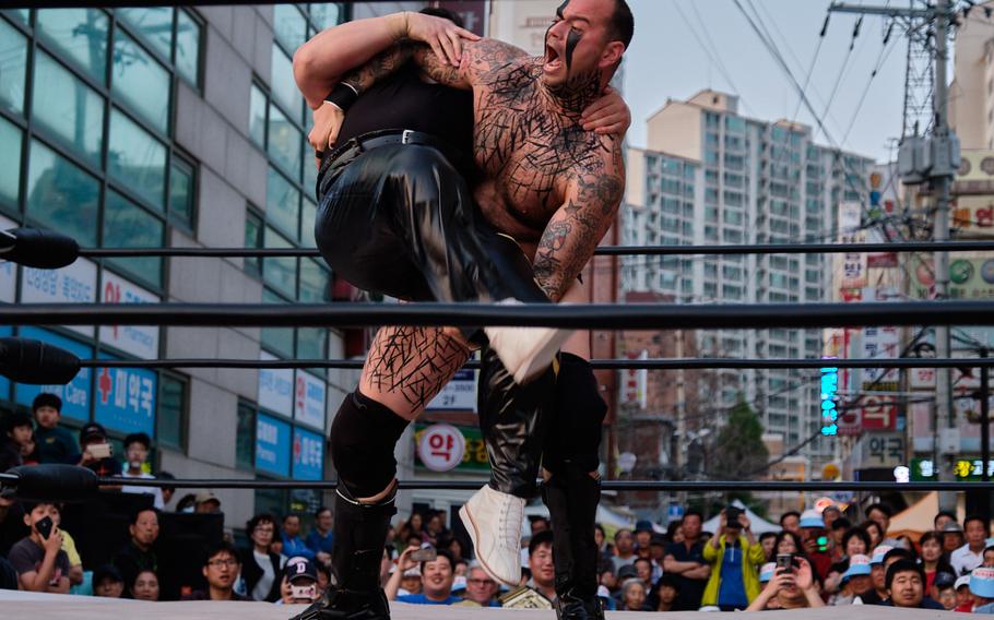 Tech. Sgt. Gregory Gauntt of the 8th Logistics Readiness Squadron at Kunsan Air Base prepares to body slam his opponent during a match in Goyang, South Korea, June 2, 2019.