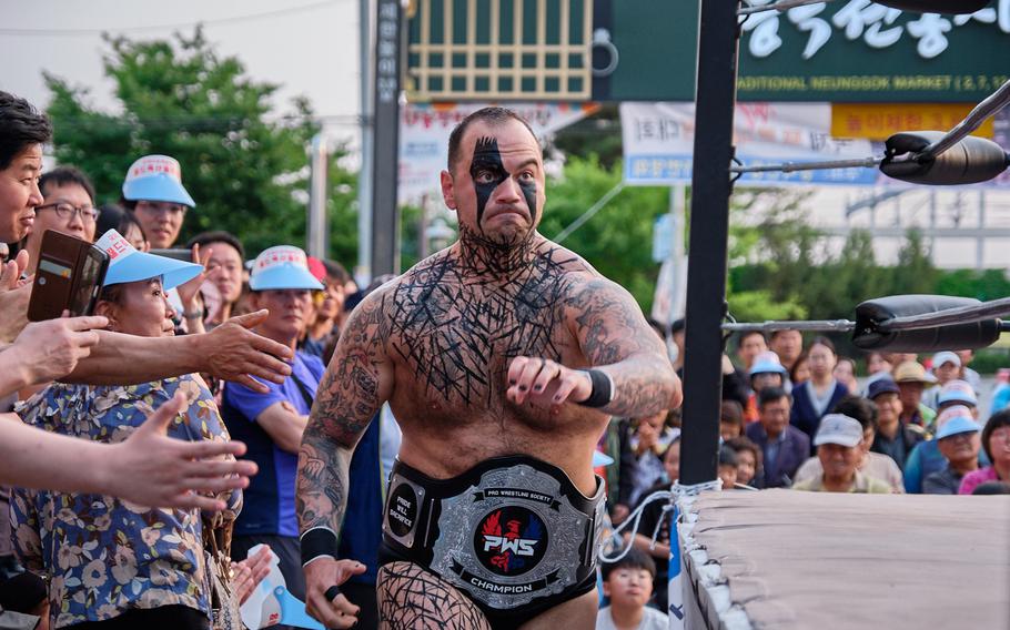 Tech. Sgt. Gregory Gauntt, 8th Logistics Readiness Squadron at Kunsan Air Base sprints before jumping into the wrestling ring in Goyang, South Korea, June 2, 2019.