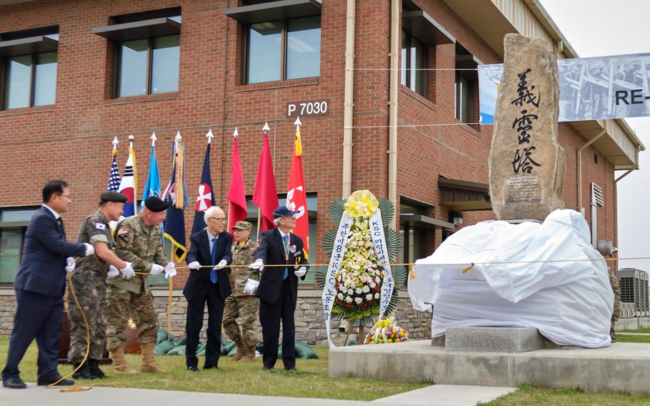 Eighth Army commander Lt. Gen. Michael Bills, center, helps two Korean Service Corps veterans, right, unveil the corps' memorial monument during a rededication ceremony at Camp Humphreys, South Korea, June 9, 2019.