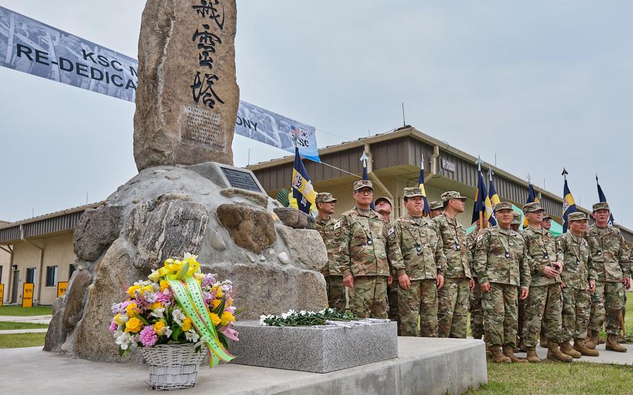 Korean Service Corps paramilitary members pose beside a tribute to fallen KSC members during a rededication ceremony for the monument at Camp Humphreys, South Korea, June 9, 2019.