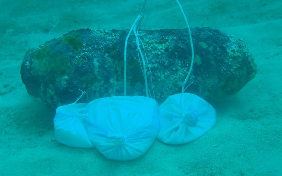 Unexploded ordnance is secured to the seafloor after being removed from Naha Military Port, Okinawa, Tuesday, June 11, 2019.