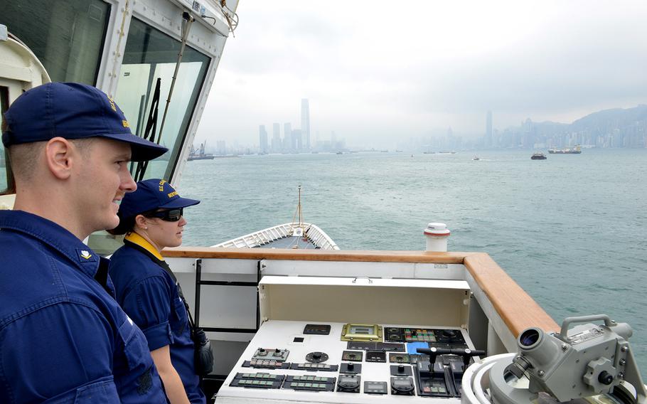 Petty Officer 3rd Class Brendan Hoban and Ensign Cristina Sandstedt monitor vessel traffic as the Coast Guard cutter Bertholf approaches Hong Kong, April 15, 2019.